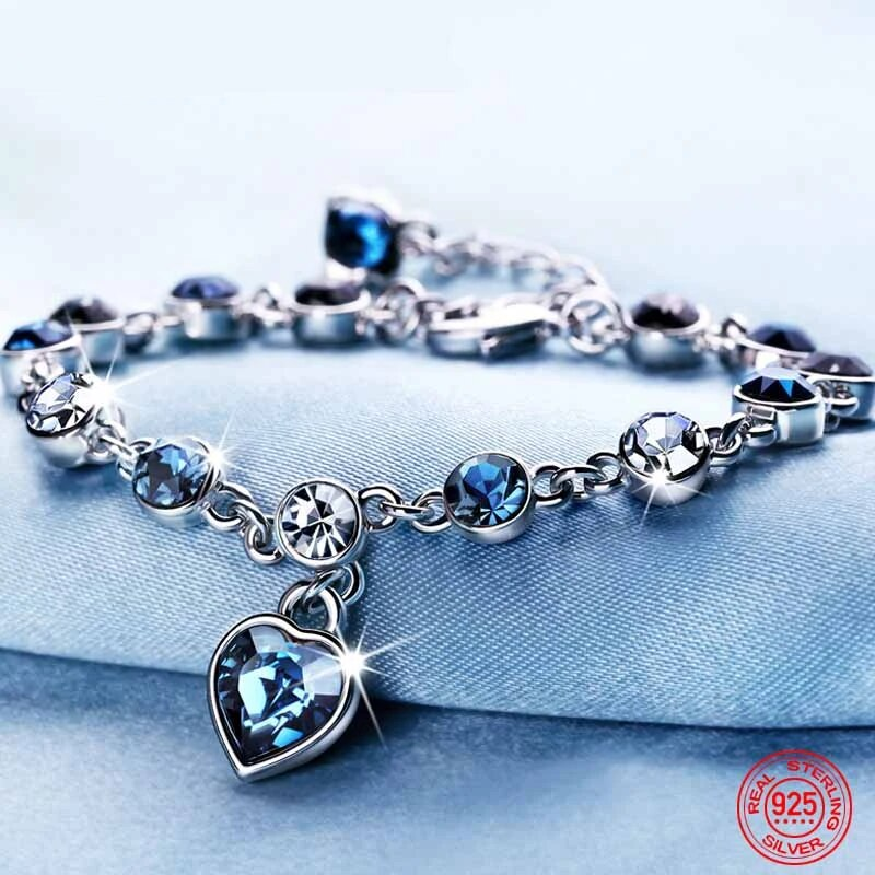 Armband aus 925er Sterlingsilber mit blauen Kristallen und Herzanhänger, eleganter Schmuck.