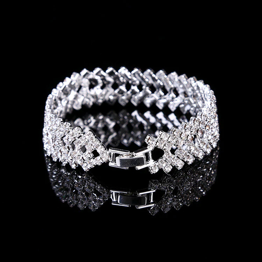 Silbernes Armband mit Kristallen, elegantes Schmuckstück, glänzend, für Damen, auf schwarzem Hintergrund.