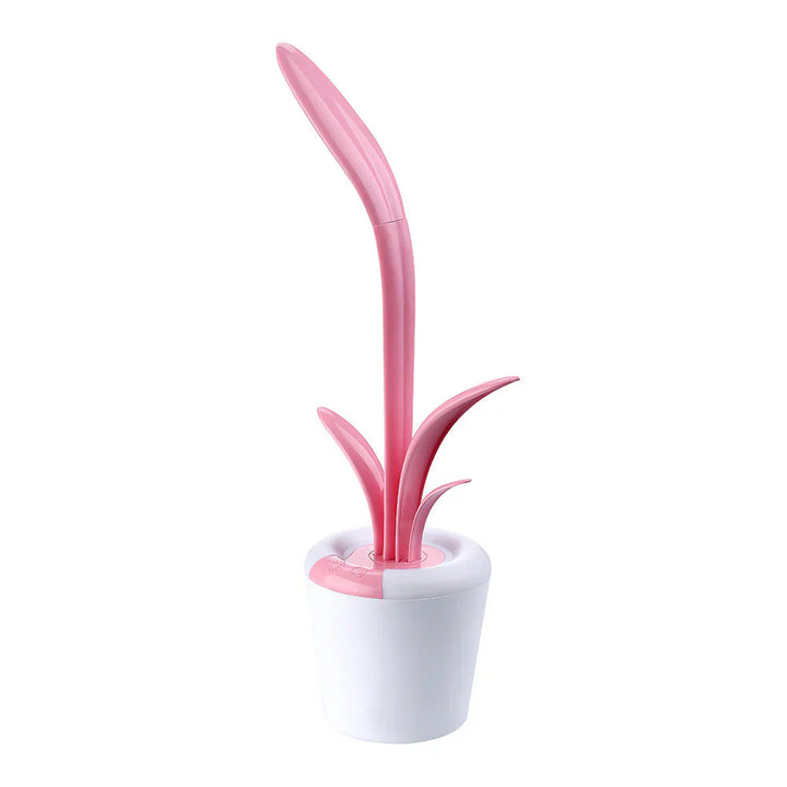 Rosa Toilettenbürste in Blütenform mit weißem Halter, modernes Badezimmerzubehör.