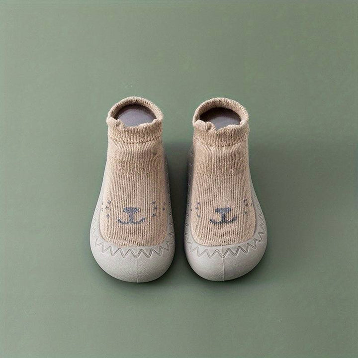 Beige Babyschuhe mit Tiermotiv, rutschfest, weiche Sohle, ideal für Kleinkinder, Unisex.