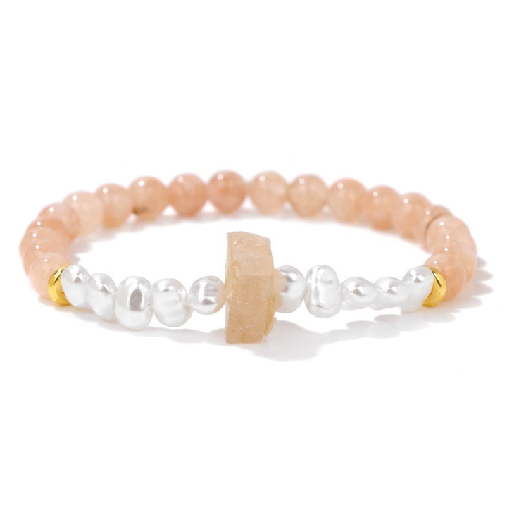 Perlenarmband mit rosa und weißen Perlen, goldenen Akzenten, elegantes Schmuckdesign.
