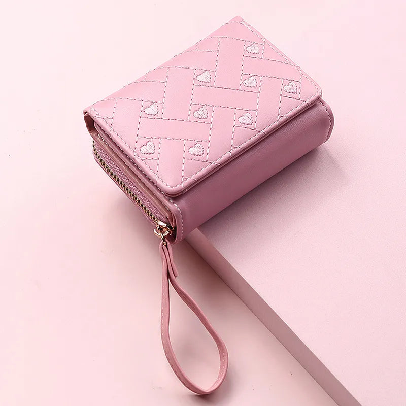 Rosa Damen-Geldbörse aus Leder mit Reißverschluss und Riemen, stilvolles Design.
