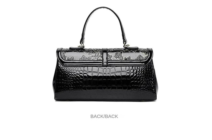 Schwarze Lederhandtasche mit Krokodilprägung, Blumenmuster, elegantes Design, Damenmode.