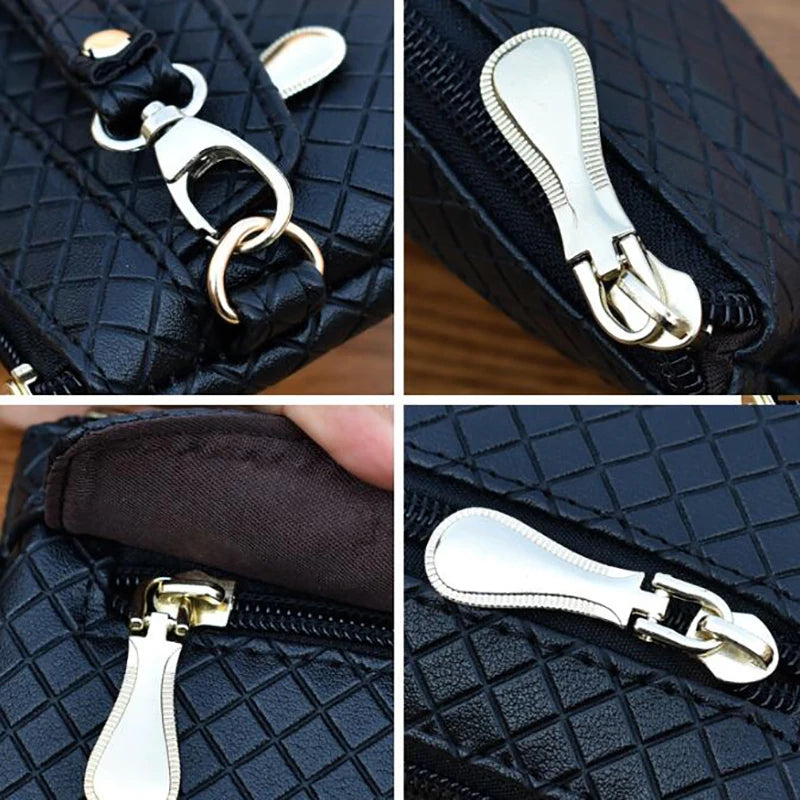 Schwarze Lederhandtasche mit silbernen Reißverschlüssen und Karabinerhaken, modisches Accessoire.