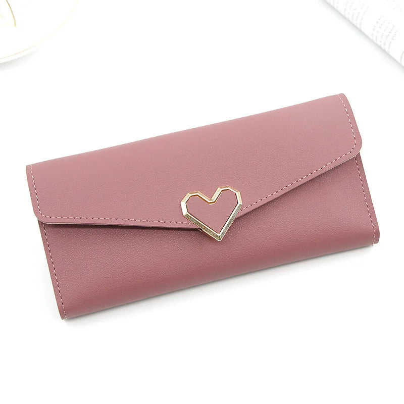 Rosa Damen-Geldbörse aus Leder mit Herzverschluss, modisch und elegant.
