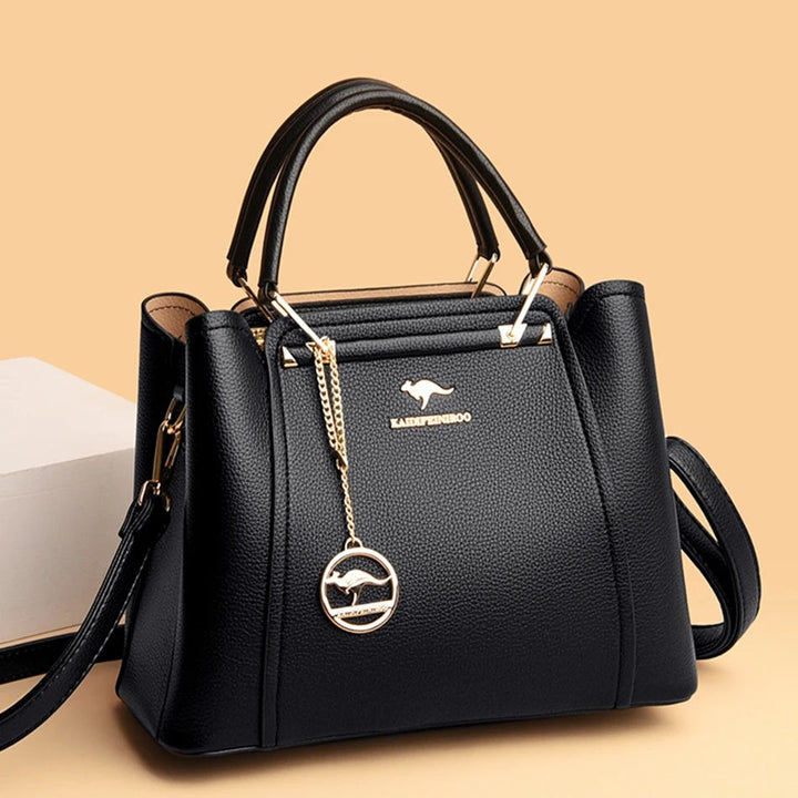 Schwarze Lederhandtasche mit goldenen Details, elegantes Design, Damenmode Accessoire.