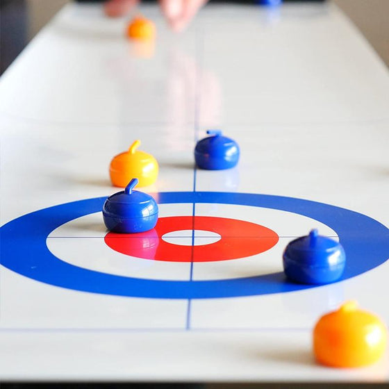 Mini-bordcurling hra pro domácnost s klouzavými kameny a magnetickými tyčemi