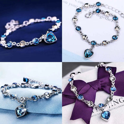 Silberarmband mit blauen Kristallen und Herzanhänger, eleganter Schmuck für Damen.