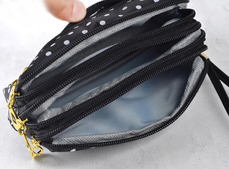 Schwarze gepunktete Geldbörse mit Reißverschlüssen, mehrere Fächer, Damen Accessoire.