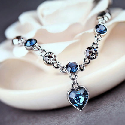 Silberne Halskette mit blauen Kristallen und Herzanhänger, eleganter Schmuck für Damen.