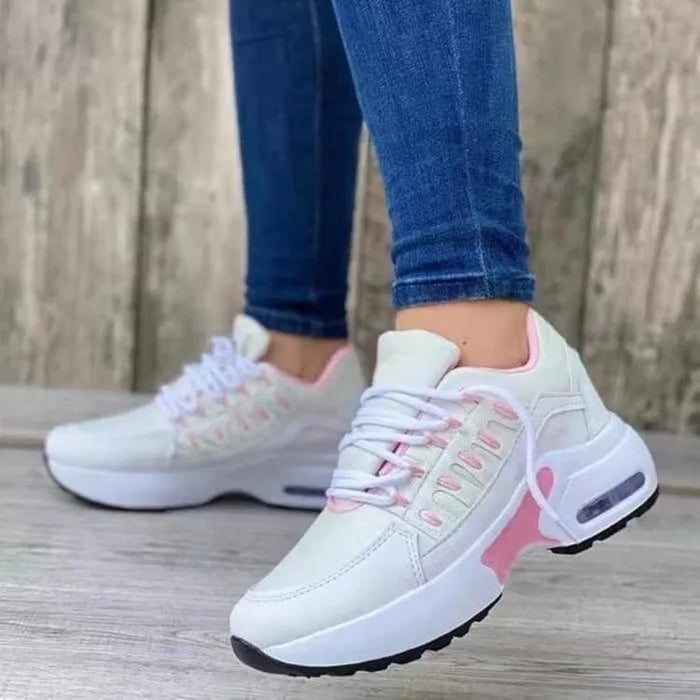 Weiße Damen-Sneaker mit rosa Akzenten, bequem, modern, ideal für Freizeit und Sport.