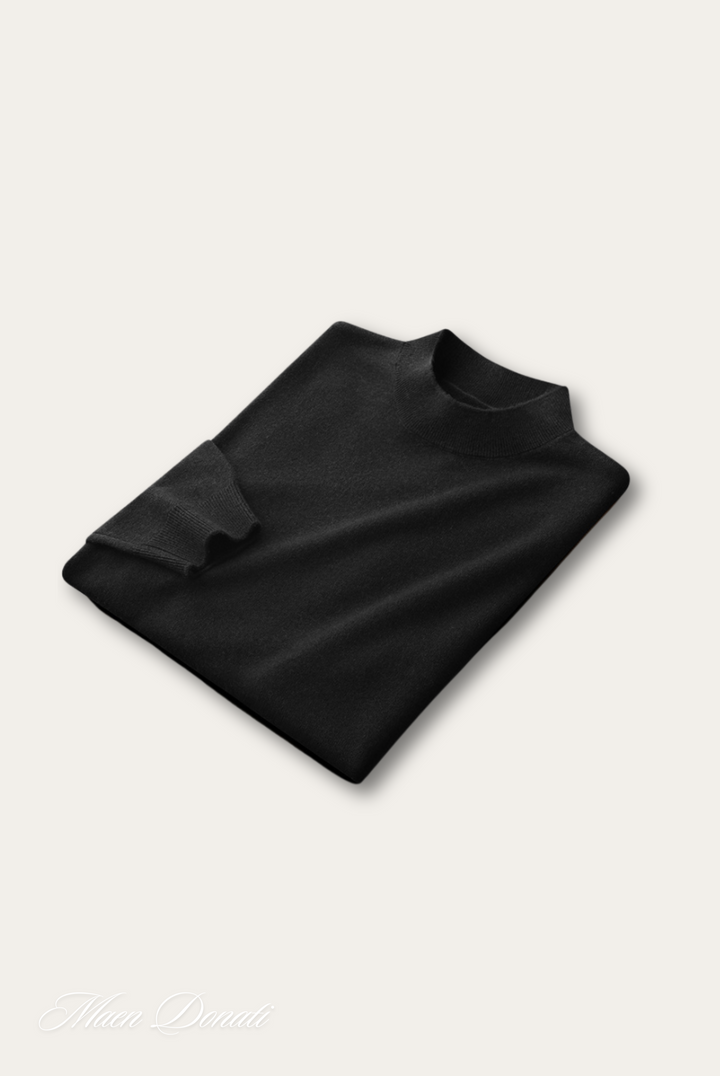 Schwarzer Rollkragenpullover aus Kaschmir, gefaltet, elegantes Design, hochwertige Mode.