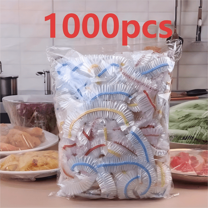 Sáček plný barevně pruhovaných elastických krytů na kuchyňské lince vedle misek s jídlem přikrytých fólií. 3