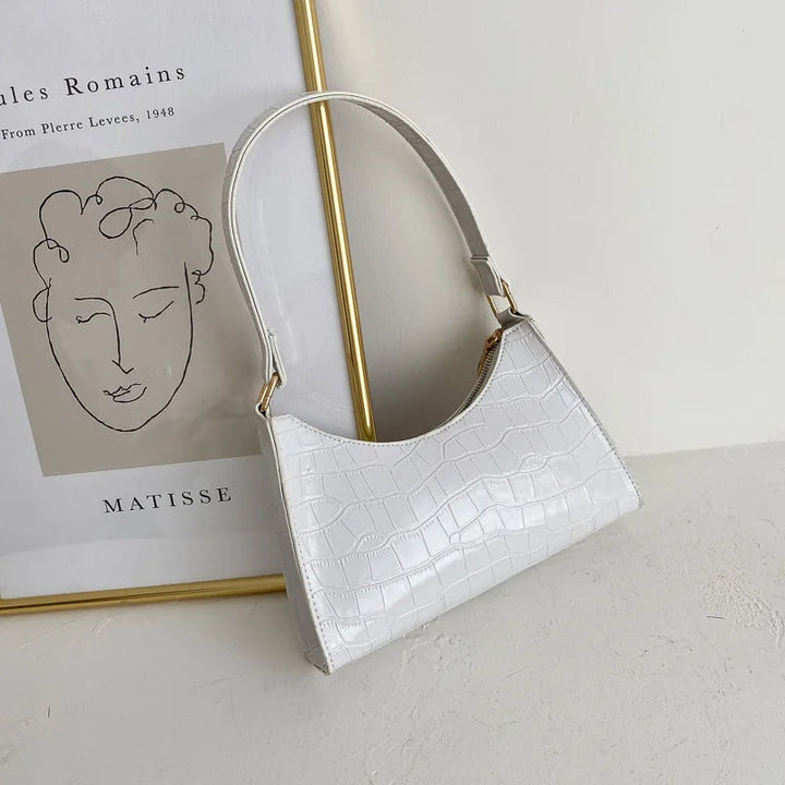 Weiße Krokodilleder-Handtasche, elegant, modern, Damenmode, minimalistisch, stilvoll.