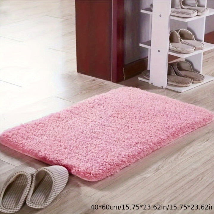 Rosa flauschiger Teppich, rechteckig, 40x60 cm, auf Holzboden neben Schuhregal.