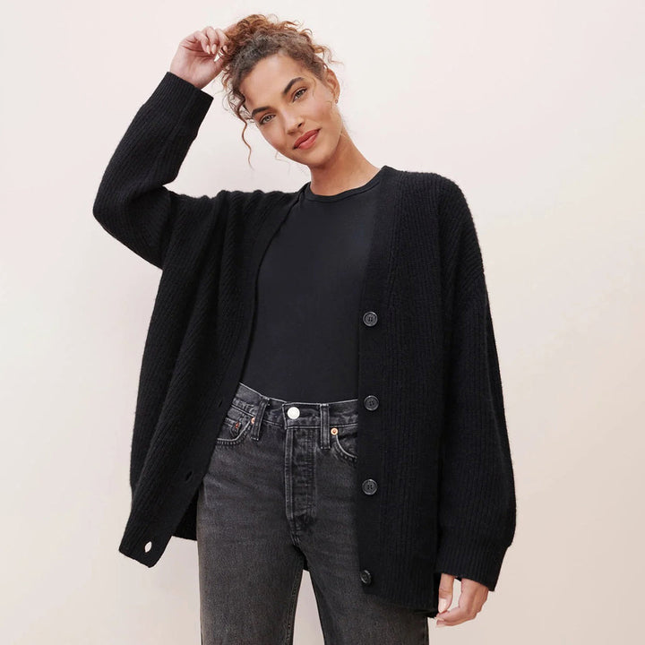 Frau trägt schwarzen Strick-Cardigan, lässig, modisch, Herbstmode, Damenbekleidung.