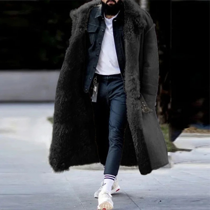 Mann in schwarzem Lammfellmantel, Jeansjacke, weißem T-Shirt, lässiger Wintermode.