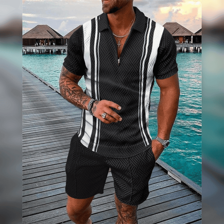 Mann in schwarz-weiß gestreiftem Hemd und Shorts auf Holzsteg am Wasser, Sommermode.