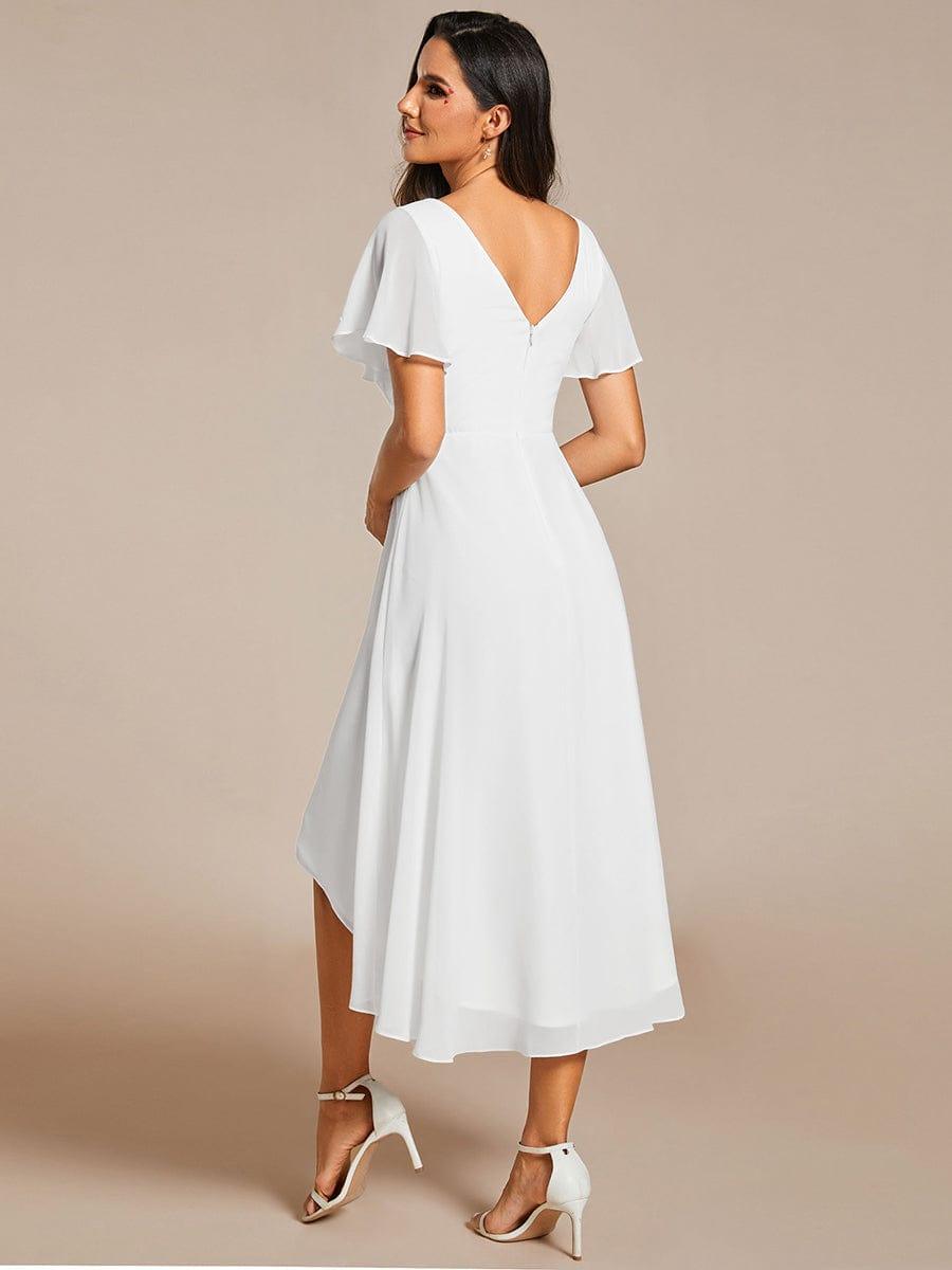 Back view of the white chiffon dress showing the deep V-shaped back with a zipper and the longer back hem. 69