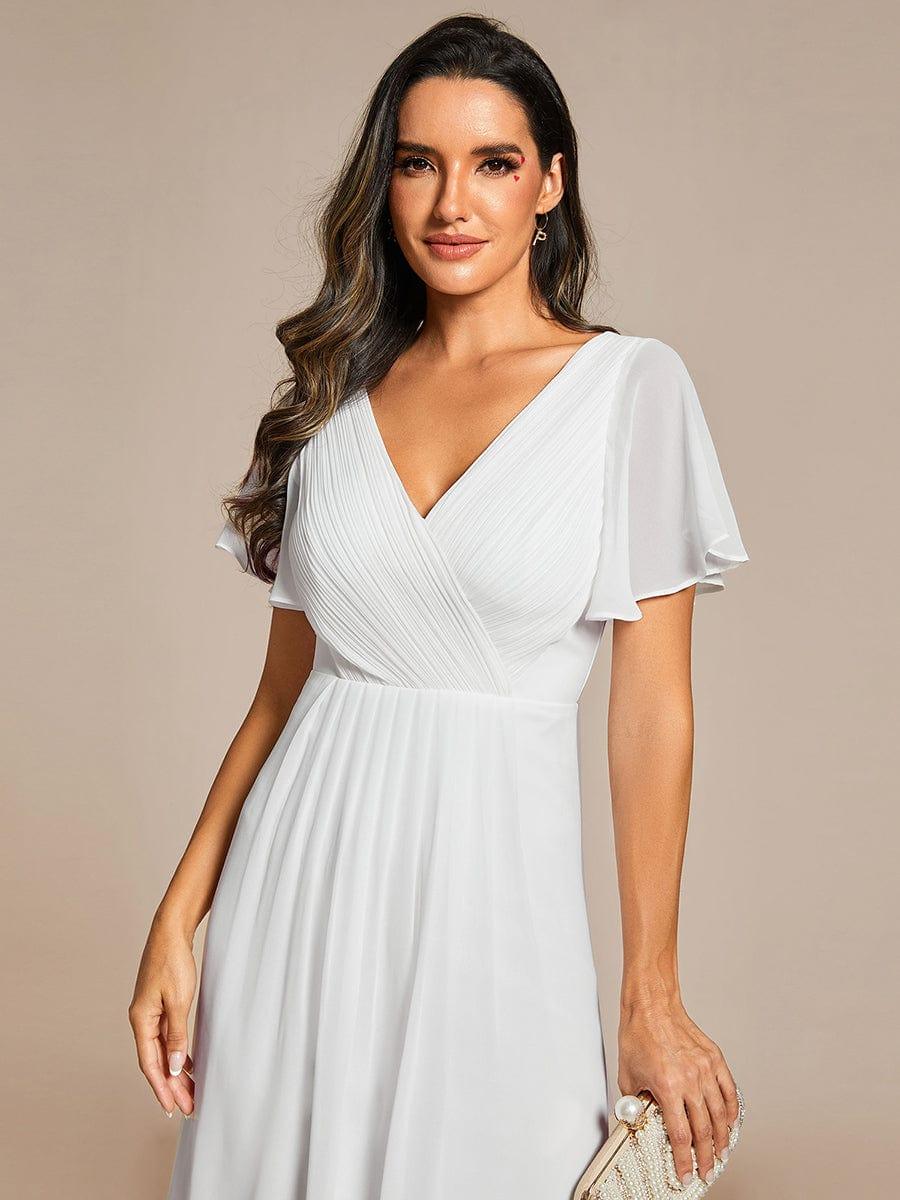 Close-up of the white chiffon dress bodice with pleated wrap detail, V-neckline and sheer flutter sleeves. 70