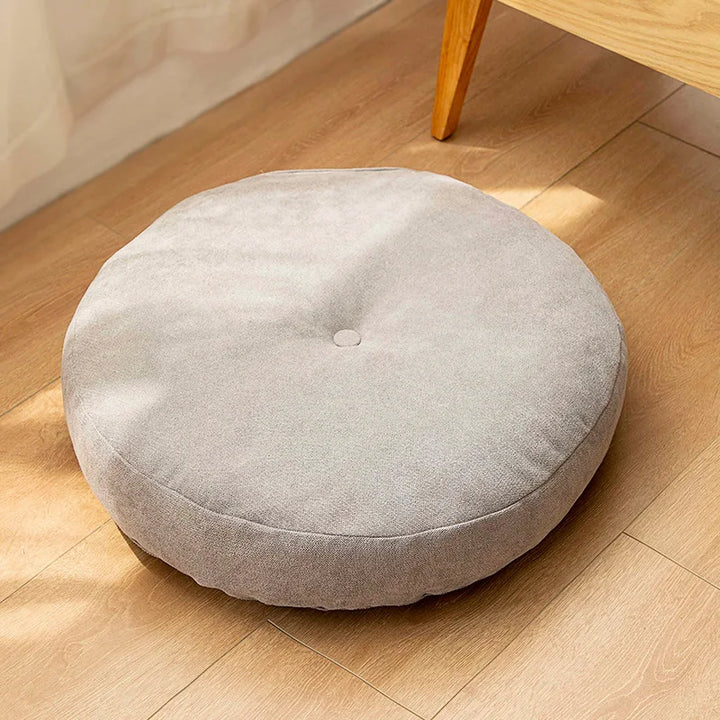 Graues rundes Bodenkissen für Meditation und Yoga, geeignet als Sitzpolster oder Pouf.