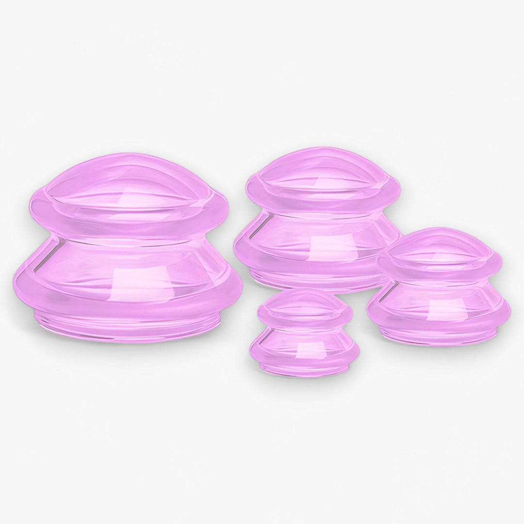 Vier rosa Silikon-Schröpfgläser, verschiedene Größen, Massage- und Wellness-Zubehör.