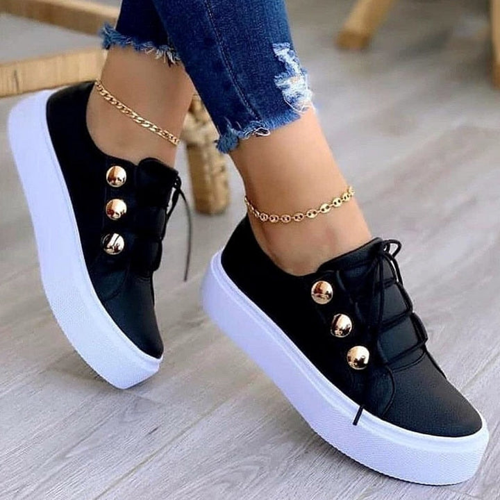 Schwarze Damen-Sneaker mit Plateau, goldene Knöpfe, Jeans, modisch, bequem.