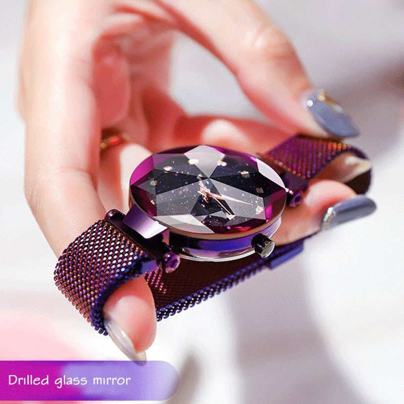 Funkelnde Damenarmbanduhr mit facettiertem Glas, lila Metallarmband, elegantes Design.