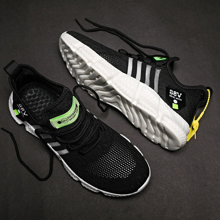 Schwarze Sportschuhe mit weißer Sohle, grüne Details, atmungsaktives Mesh, Herren Sneaker.