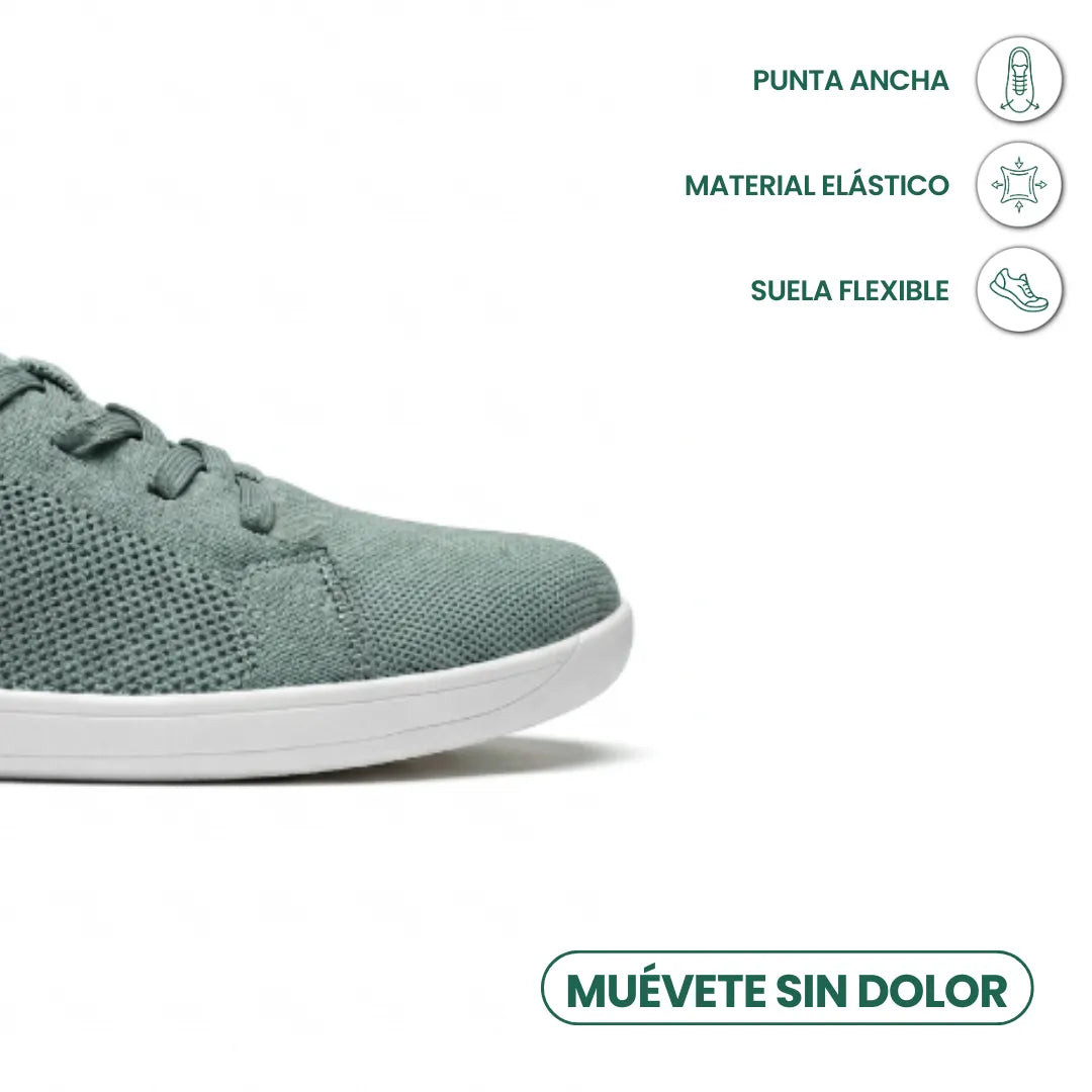 Detail široké špičky šedozelené tenisky s bílou podrážkou a ikonami elastického materiálu a ohebné podrážky. 32