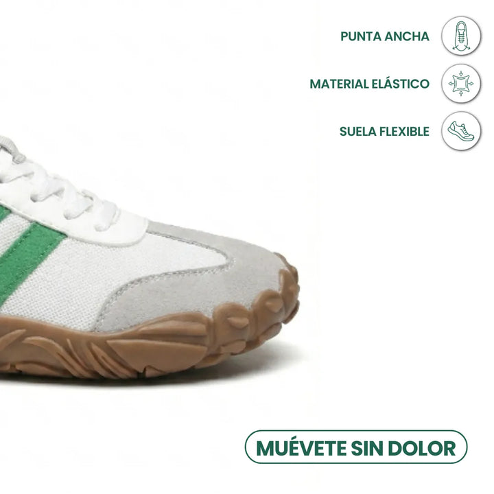 Bílá bota se zelenými pruhy v detailu přední části se širokou špičkou, pružným materiálem a ohebnou podrážkou. 32