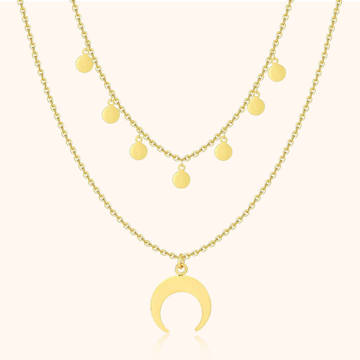 Goldene Halskette mit Halbmond-Anhänger und runden Anhängern, modischer Schmuck.
