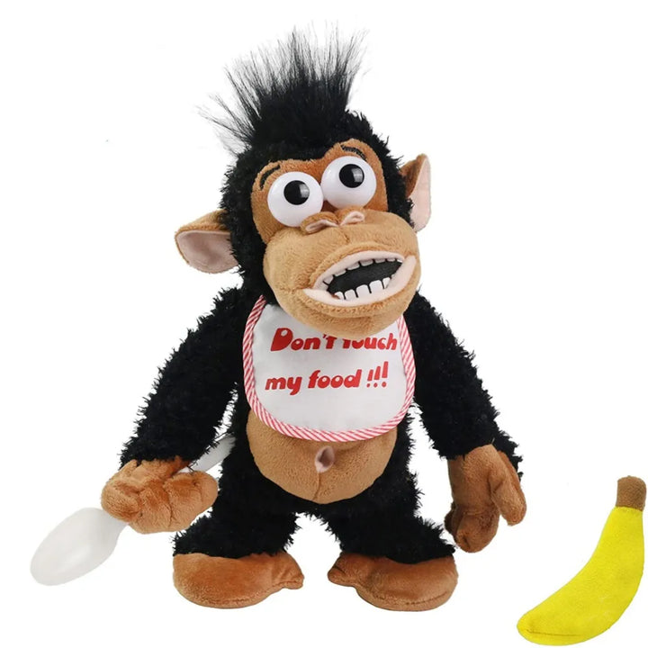 Schwarzer Plüschaffe mit Lätzchen, Löffel und Banane, lustiges Spielzeug für Kinder.