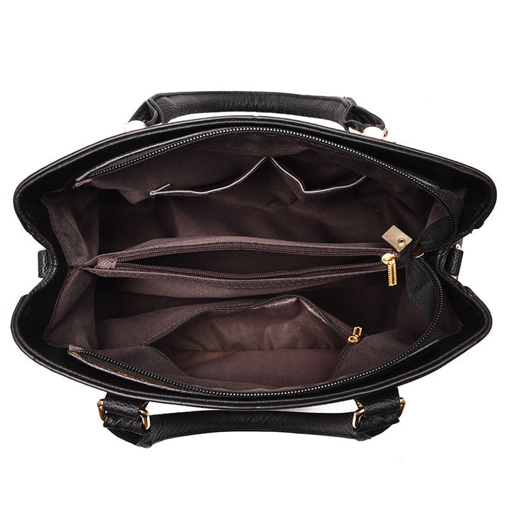 Schwarze Lederhandtasche mit mehreren Fächern und Reißverschlüssen, elegante Damenmode.