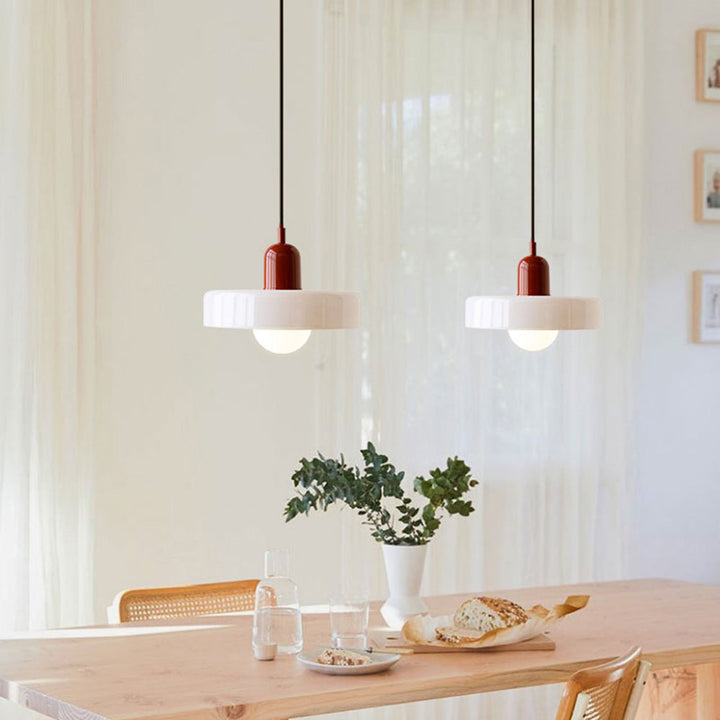 Zwei moderne Pendelleuchten über Esstisch, weiß-rot, skandinavisches Design, Esszimmerbeleuchtung.