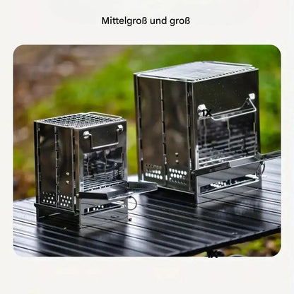 Zwei Edelstahl-Holzöfen, klappbar, für Camping, Outdoor, auf Tisch im Freien.