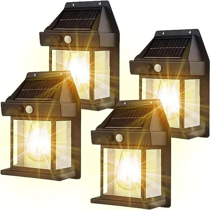 Vier schwarze, wasserdichte Solar-Wandlampen mit Glühfaden für Gartenbeleuchtung.