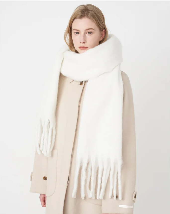 Frau mit weißem Schal aus Wolle, eleganter Wintermantel, Modeaccessoire, Damenbekleidung.