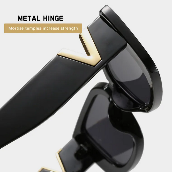 Schwarze Retro-Katzenaugen-Sonnenbrille mit Metall-Scharnier und goldenen Details.