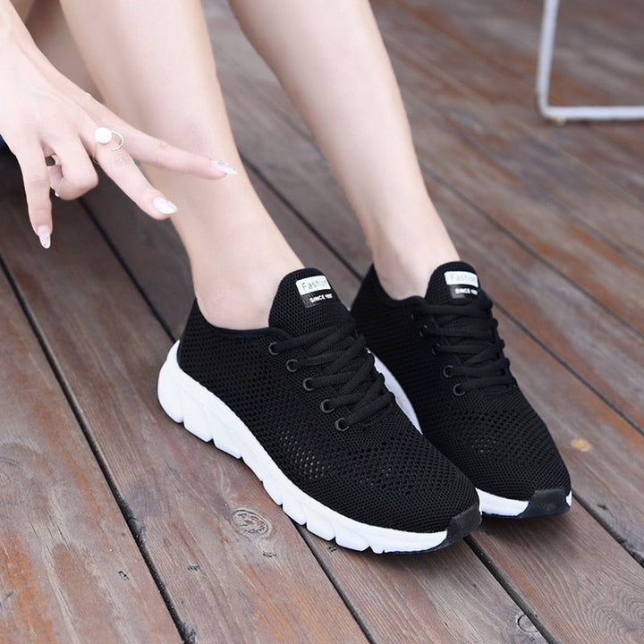 Schwarze Damen-Sneaker aus Mesh mit weißer Sohle, atmungsaktiv, modisch, bequem.