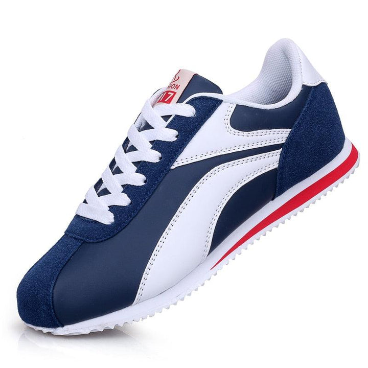 Blauer und weißer Sneaker, Herren-Laufschuh, sportlich, bequem, mit rotem Akzent.