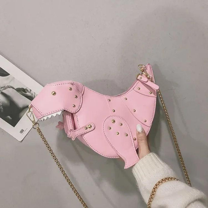 Rosa Dinosaurier-Handtasche aus Leder mit goldener Kette, modisches Accessoire für Damen.
