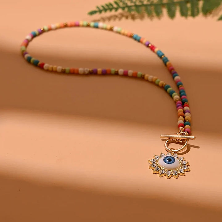 Bunte Perlenkette mit Auge-Anhänger, modisches Schmuckstück, Damenaccessoire, Boho-Stil.