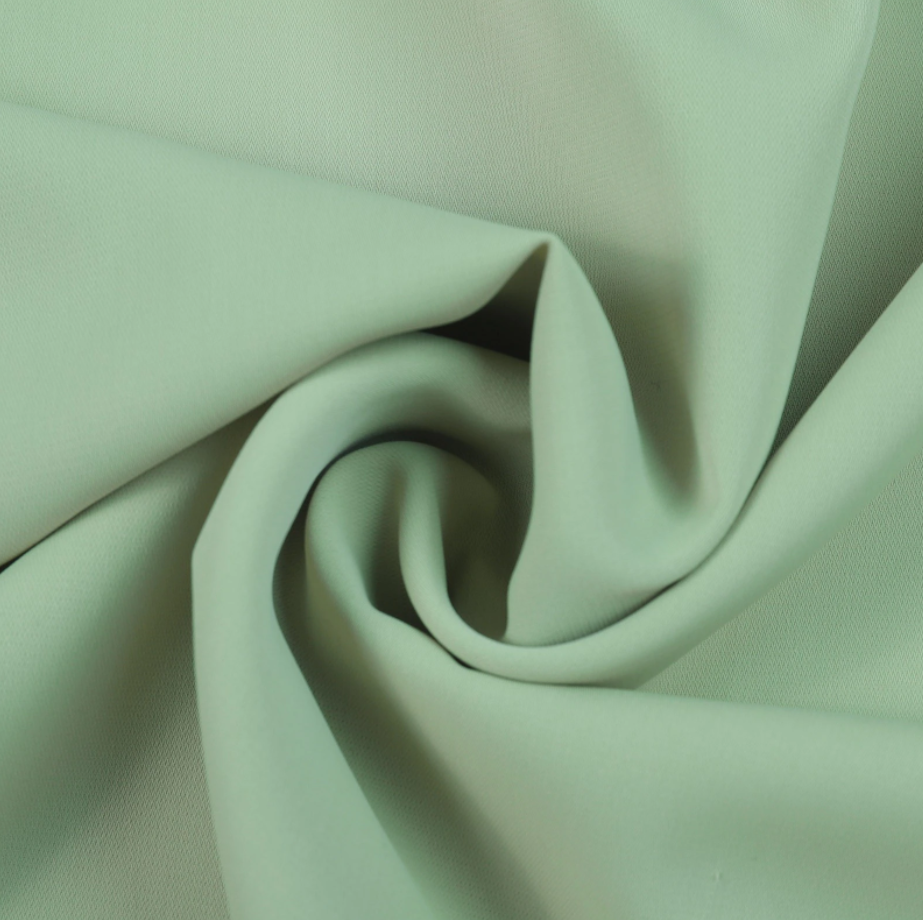 Mintgrüner Stoff, weicher Polyester, ideal für Bekleidung und Dekoration.
