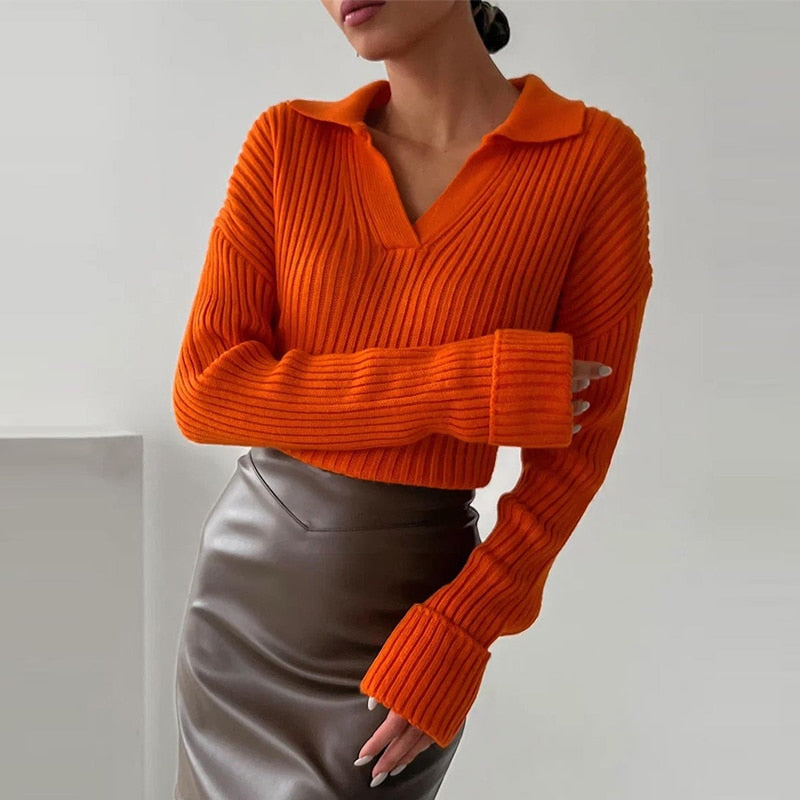 Frau in orangefarbenem Strickpullover und braunem Lederrock, modisch, elegant, Herbstmode.