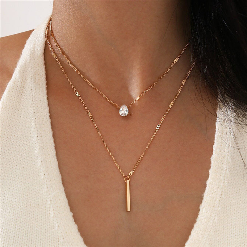 Goldene Halskette mit Kristallanhänger, geometrisches Design, Damenmode, Vintage-Stil.