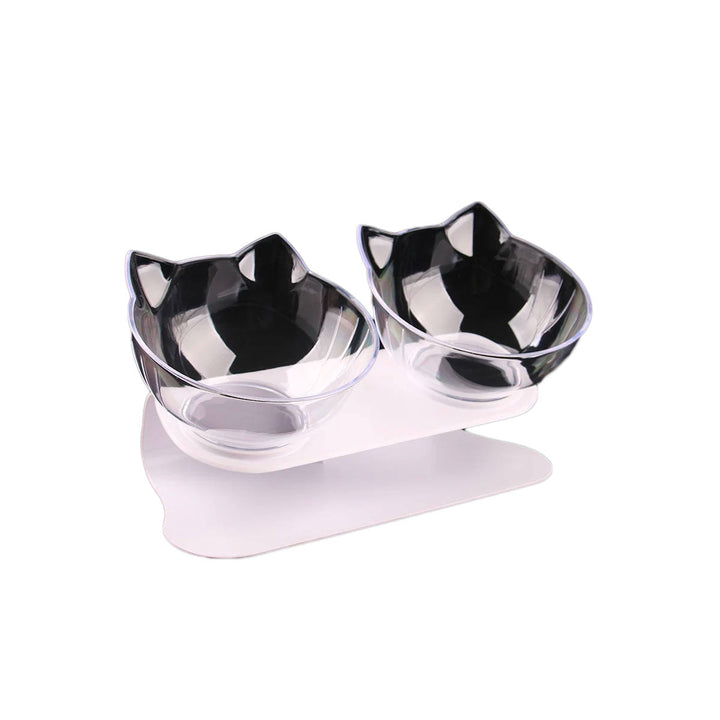 Doppel-Katzenfutternäpfe, transparent, geneigt, mit Katzenohren-Design auf weißem Ständer.