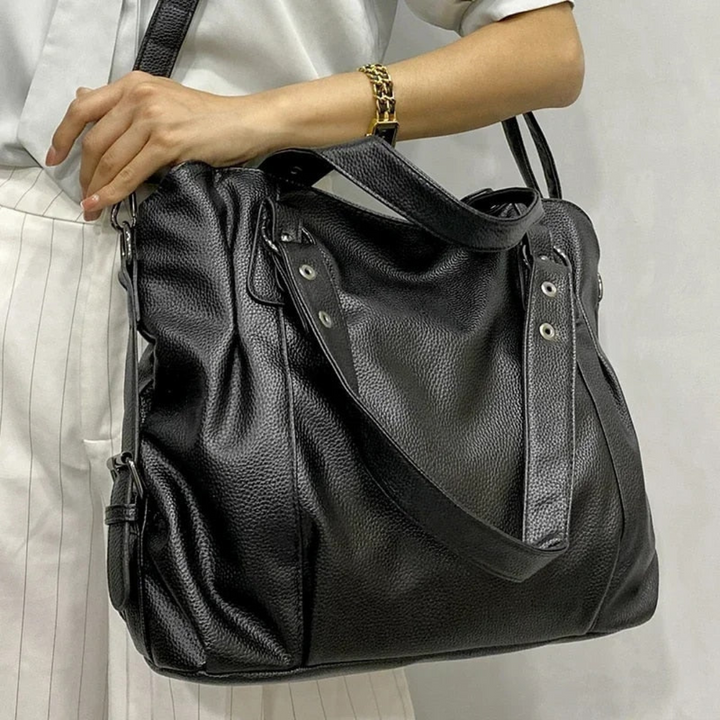 Damenhandtasche aus schwarzem Leder, elegant, mit Schulterriemen, modisch und geräumig.