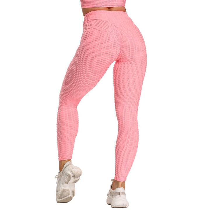 Frau in rosa, nahtloser, strukturierter Leggings, Sportbekleidung, Fitnessmode, Rückansicht.