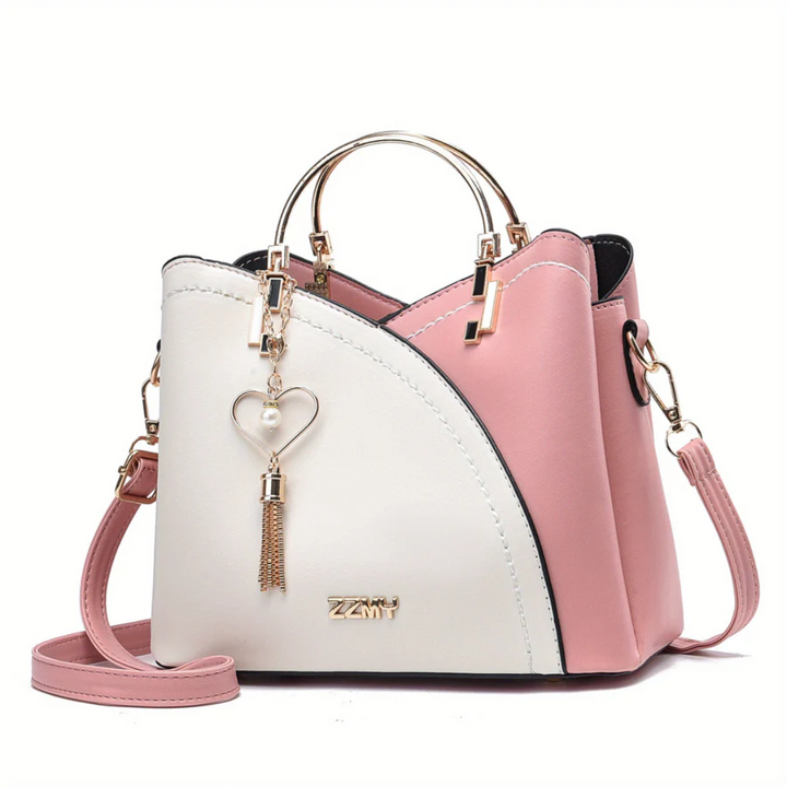Rosa-weiße Damenhandtasche mit Herzanhänger, Leder, goldene Details, modisch, elegant.